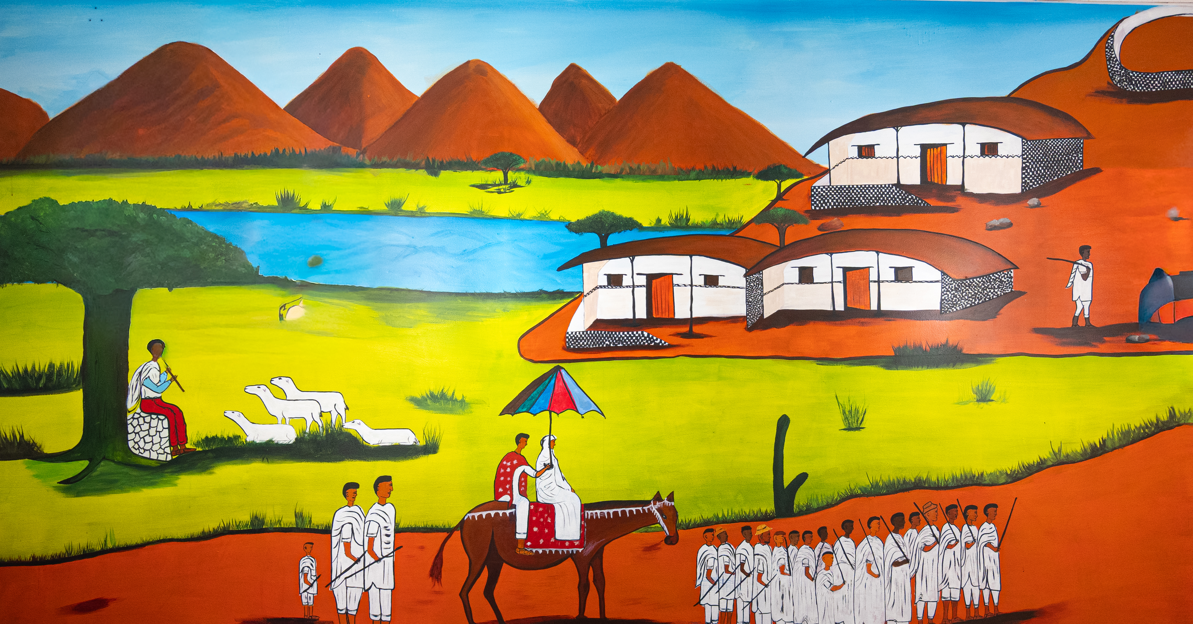 Traditional Eritrean village mural depicting daily life with sheep and traditional architecture
